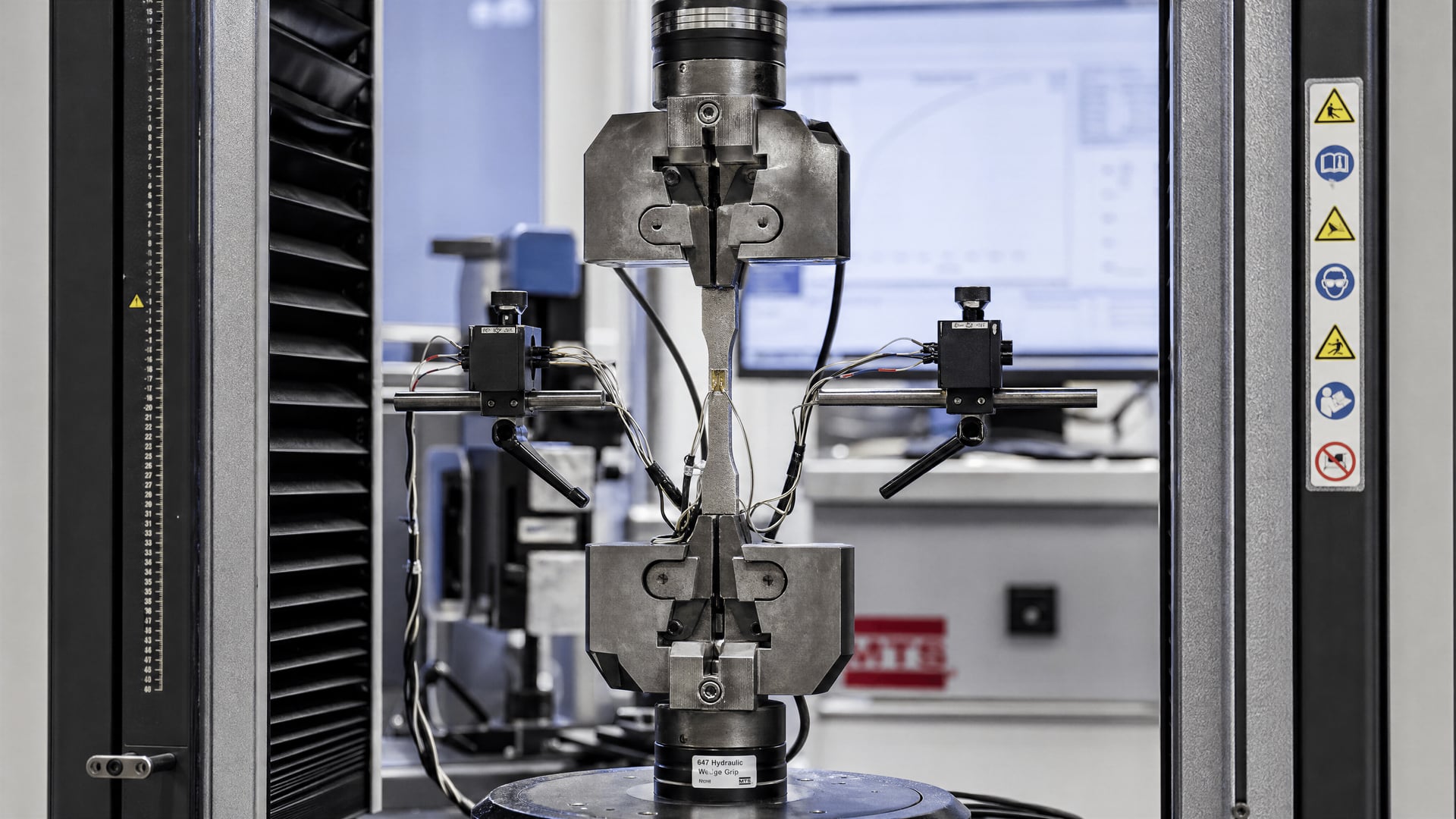 Instrumented tensile test of a high-strength steel specimen in a materials laboratory