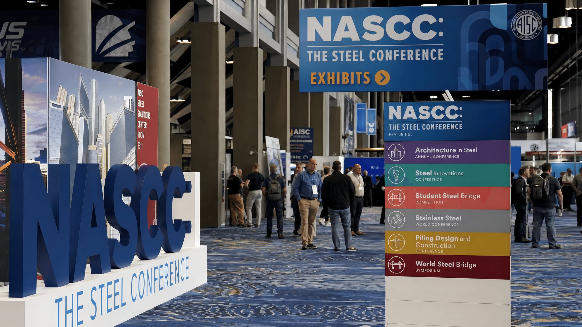 Atlanta exhibition hall displaying NASCC specialty conference signs and steel industry exhibits